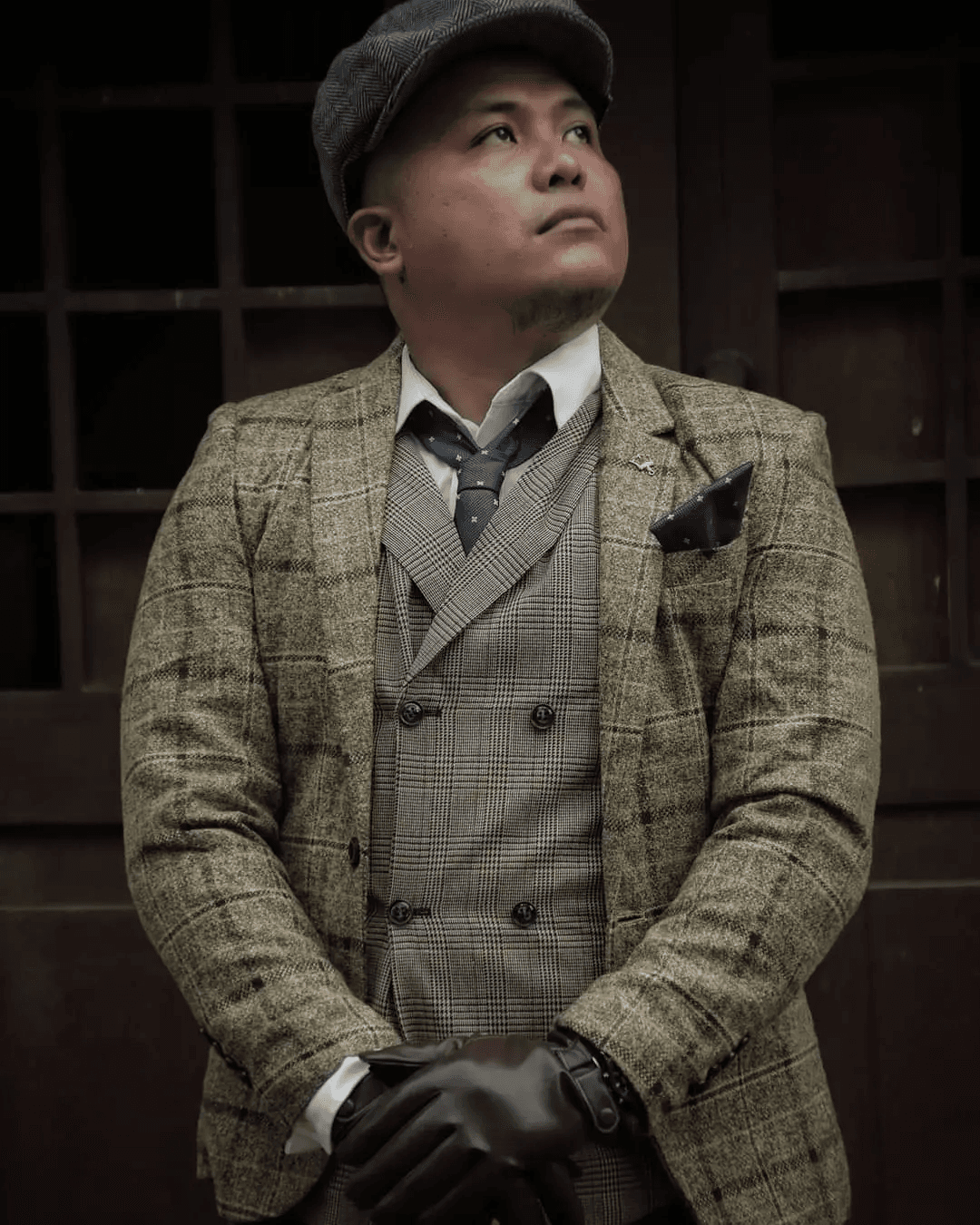 Carl Grefalde wearing a tweed suit and flat cap